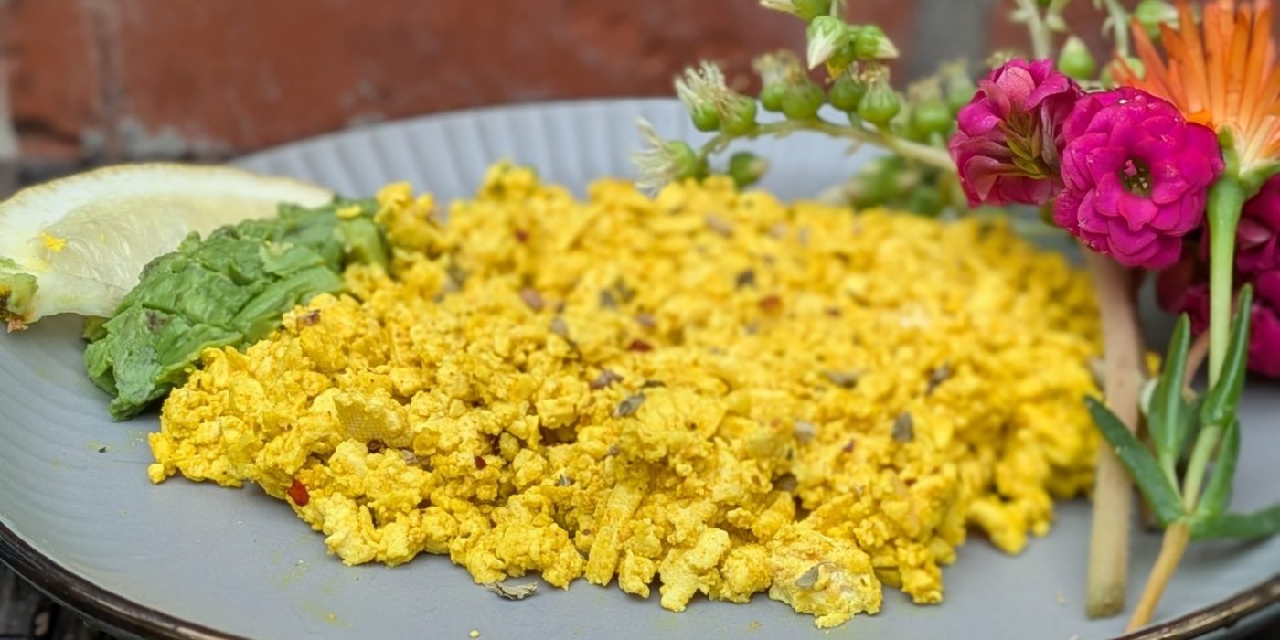 Erin Resch photo of High protein tofu scrambled eggs for your high-protein-plant-based-recipe list. Image of tofu eggs with flowers.