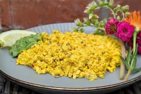 Erin Resch photo of High protein tofu scrambled eggs for your high-protein-plant-based-recipe list. Image of tofu eggs with flowers.