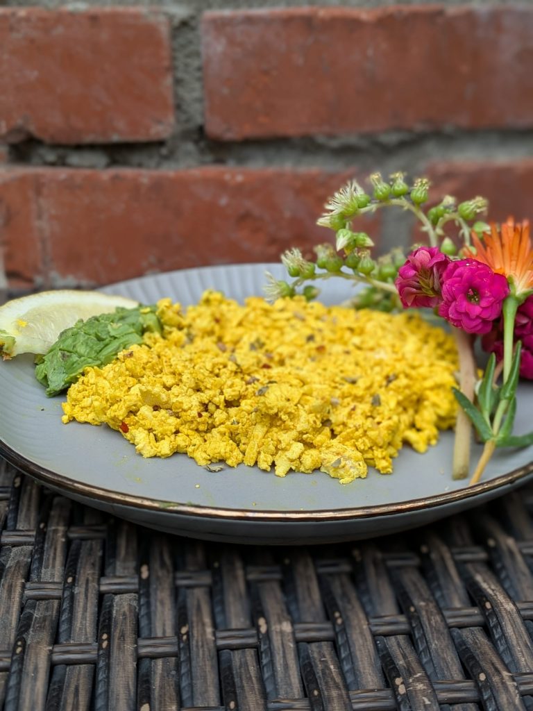 Erin Resch photo of High protein tofu scrambled eggs for your high-protein-plant-based-recipe list. Image of tofu eggs with flowers.