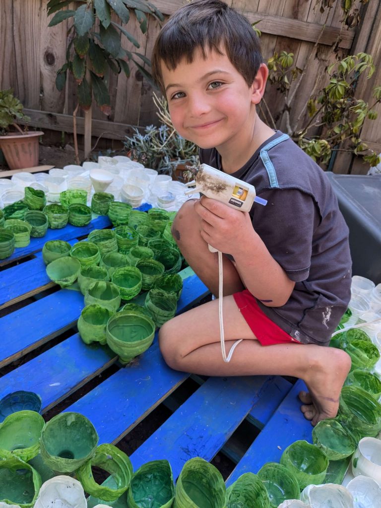 burning Man sustainable art installation. Image of Jackson Resch making an upcycled Earth pallet art installation.