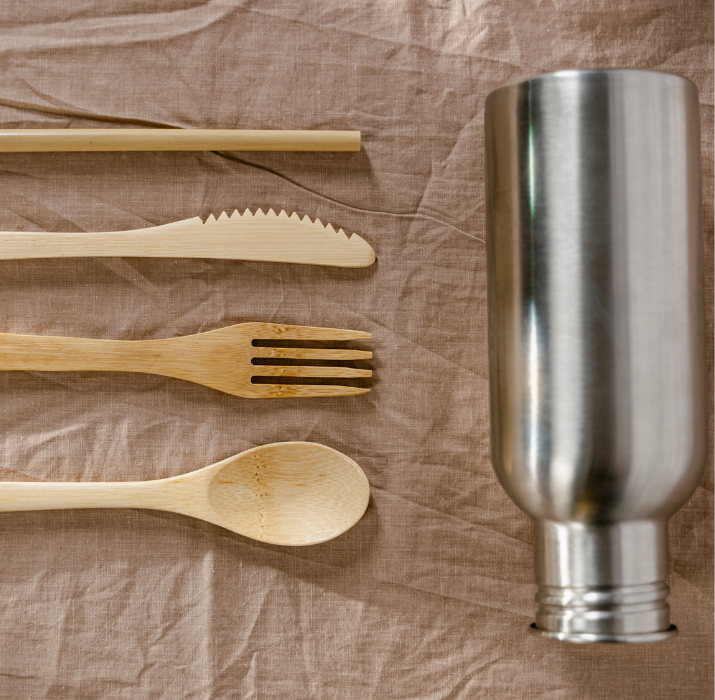 Zero-Waste Burning Man Packing List image of reusable bamboo utensils and a silver reusable water bottle.