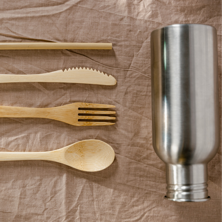 Zero-Waste Burning Man Packing List image of reusable bamboo utensils and a silver reusable water bottle.