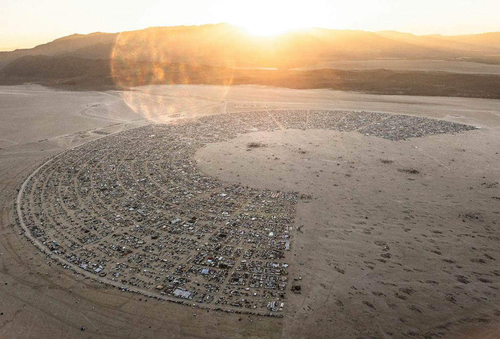 Burning Man sustainability showcased with an overhead image of Black Rock City. This image shows the semi circle clock shape of all the camps on a map. 