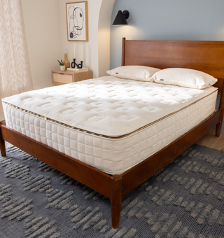 Wooden bed frame of organic naturepedic mattress in a neutral bedroom setup to showcase the best organic mattress 2026